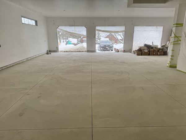 Smooth new concrete floor in a large multi-bay garage.